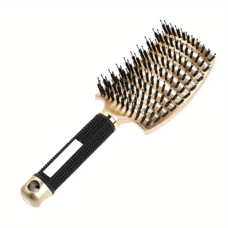 Hairbrush with black bristles and gold handle on a white background
